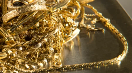 Close up of gold jewelry on a scale ready to be weighed.