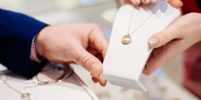 Man buying necklace in jewelry store. Sale and customer service in the store