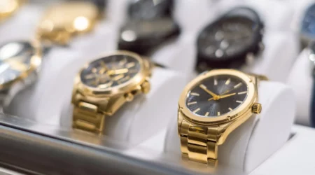 High-end gold-colored watches, exposed behind the window of a watch shop